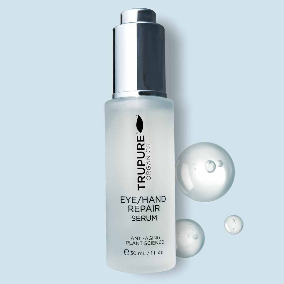 Eye and Hand Repair Serum bottle on a pastel background