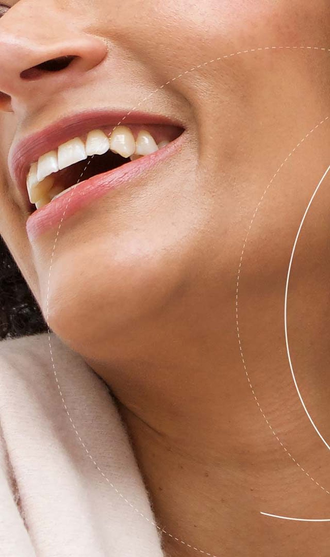 A smiling woman over 55 with warm brown skin and natural curls, from TruPure Organics campaign imagery