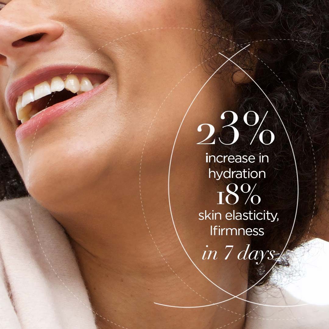 A smiling woman over 55 with warm brown skin and natural curls, from TruPure Organics campaign imagery